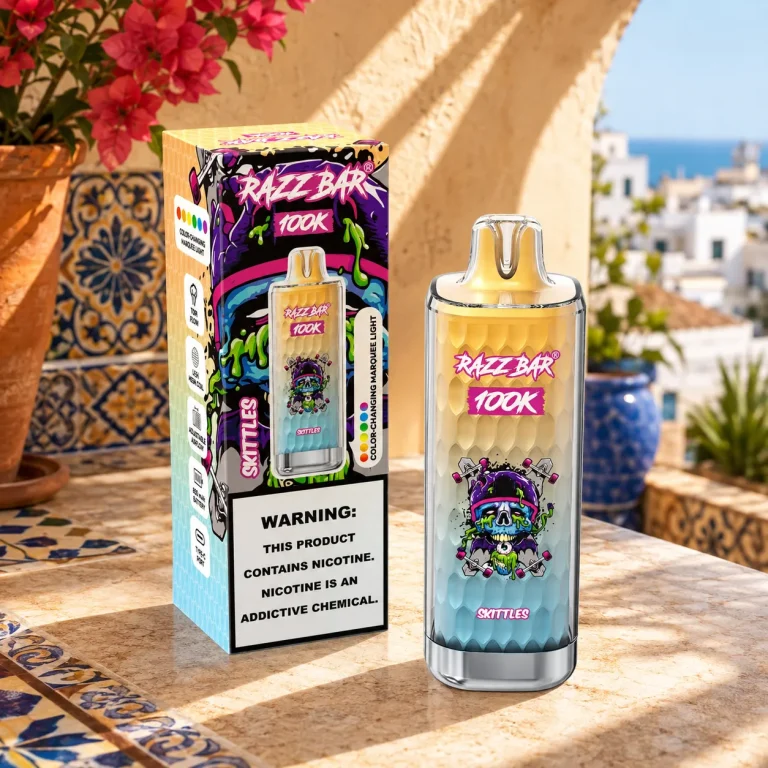 Razz Bar 100K puffs disposable vape in Skittles flavor with retail box on Spanish tiled balcony.